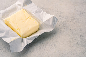 Cooking or breakfast package butter on vintage white background
