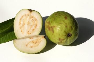 Green Guava Halves and Whole Fruit on White Background