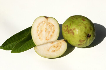 Fresh Green Guava Cut in Half with Whole Fruit on White