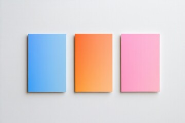 Fototapeta premium three blank colorful notepads on a white background