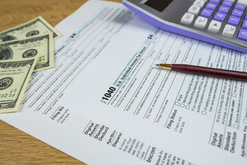 Obraz premium us tax forms 1040. 2024 year, business tax time concept.