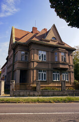 Old historic family house. Old house with lots of windows. A street in a small historic town. Family, housing. A house illuminated by the morning rising sun.
