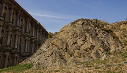 Rocky hill in front of the castle. A rocky hill overgrown with grass. Natural formation, rock....