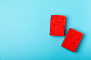 Colorful dish sponges on textured background. Kitchen sponge. Cleaning concept, cleaning service. Dishwashing liquid with clean and dirty dishes plate. Place for text, copy space. Wash the dishes.