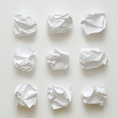Fototapeta premium nine crumpled pieces of white paper on a white background