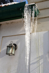 Large icicle hanging from gutter