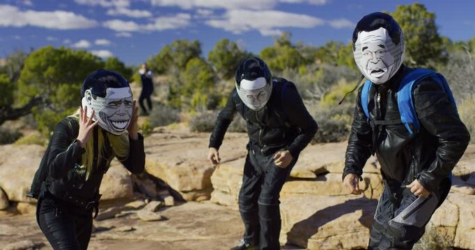 Police officer in distance catching bikers putting on parachute bags