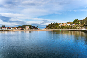 Ribadesella reflecting on the calm water of the sella river in asturias