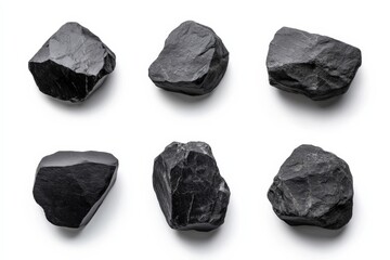 six pieces of black coal isolated on a white background