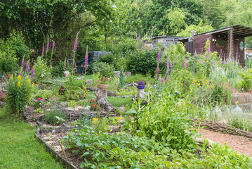 Wooden garden house and shed in a kitchen garden in the Avijl Plateau nature reserve and park