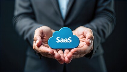 Person carefully holding a cloud icon with the word SaaS written on it, representing software as a service.