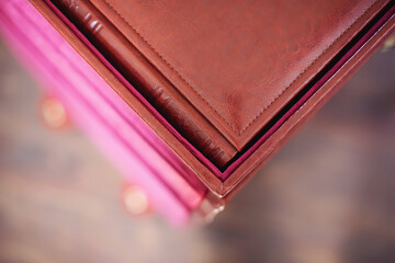 detail of photobook in brown leather binding. Wedding photo book, album family album. Photo books with embossing and a cover of genuine leather. Services of a professional photographer and designer. 