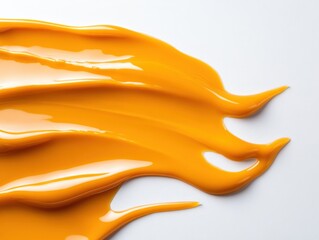 smear of yellow cosmetic product on white background