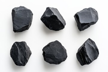 six pieces of black coal isolated on a white background