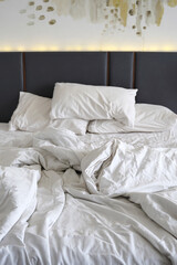 Messy bed after use. Comfortable Bedroom Concept. Hotel or home room interior concept photo