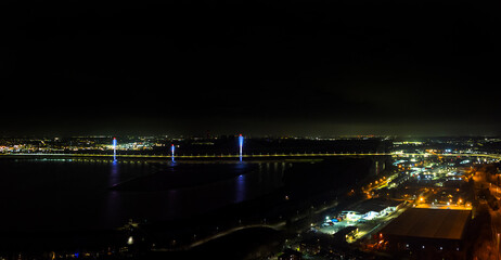 Fototapeta premium An aerial view of the Mersey Gateway Bridge at night spanning the River Mersey at Runcorn in Cheshire, UK