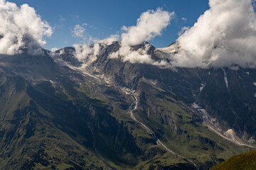 Fototapeta premium The Grossglockner mountain range with snow on the peaks and a blue sky