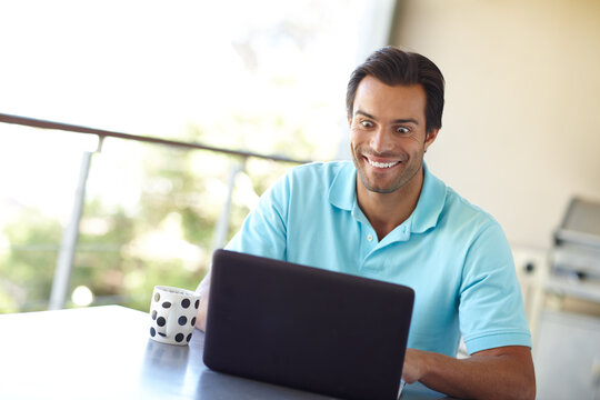Home, man and excited with laptop in balcony, remote work or email with good news for publication. House, male person or journalist with happiness for blog post, article review and reading in terrace