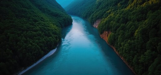 Obraz premium Aerial view turquoise river flows through lush green canyon. Background mountains. Use travel brochure