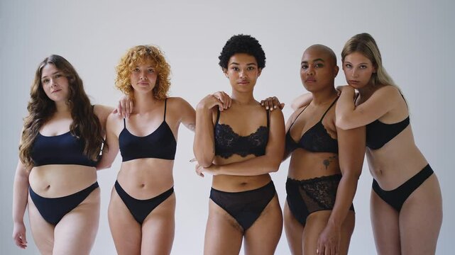 Beautiful women wearing lingerie posing for body positive concepts - Multiethnic group of female adults celebrating body acceptance, individuality, self-esteem.