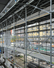 Covered facade of a reconstruction building, Scaffolding with safety nets during renovation building.