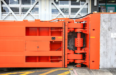 Hydraulic Hinge of big red gate at port, steel gate for Water retention and port traffic.