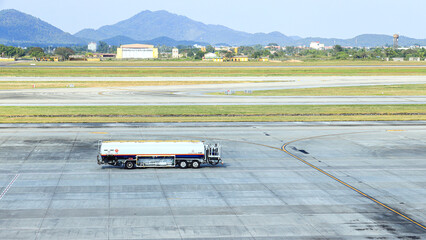 Obraz premium Ground Service fuel truck for Refueling an aircraft at aircraft bay.