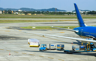 Process of Pre-flight service and handling. Luggage and catering loading at International Airport.