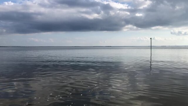seascape, smooth sea, low dark clouds, view