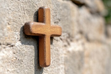 small wooden cross on a stone wall