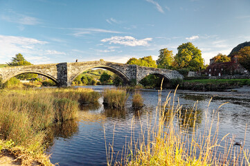 The Pont Fawr road bridge crosses the River Conwy in the old town of Llanrwst in the Conwy Valley,...