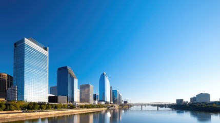 Modern Urban Riverfront with Sleek Architecture Under Clear Blue Sky and Reflective Water