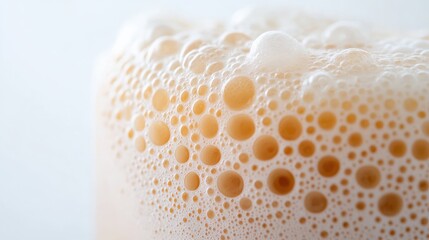 close up of bubbles in a light brown liquid, macro photography of foam texture