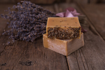 Bar soap of different colors on old wooden background