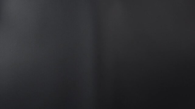 A classic film clapperboard or film slate being held and hit against a dark background. Symbolizes filmmaking video production movie filming and creative storytelling in the entertainment industry.