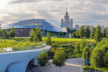 Early morning in Zaryadye Park, Moscow, with summer greenery and a distant view of the Stalinist...