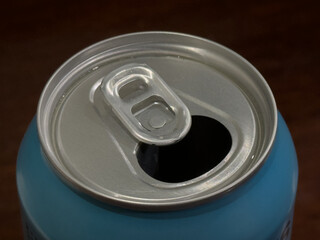 The top of an opened aluminum can with a pull-tab.