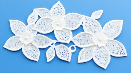 Fototapeta premium Delicate white lace flowers and leaves create an elegant pattern against a bright blue surface