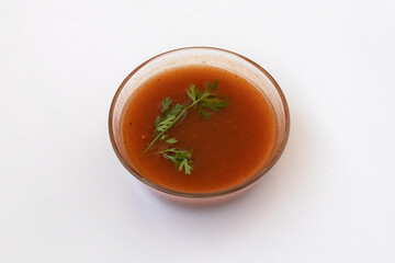 imli ki chutney - Tamarind chutney in a glass bowl on white background