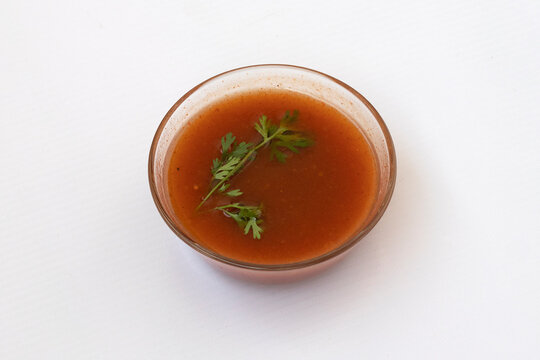imli ki chutney - Tamarind chutney in a glass bowl on white background