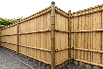Natural Bamboo Fence: A close-up view of a rustic bamboo fence constructed with carefully woven poles, creating a natural and elegant barrier.