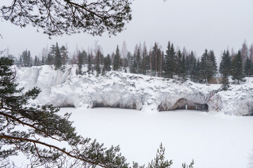 Winter in the park. Karelia Ruskeala Nature Reserve in winter. It is snowing in the forest.