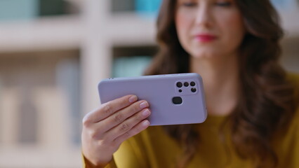 Freelancer watching video cellphone sitting workplace closeup. Woman smiling