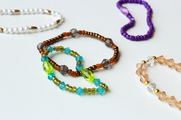 Beaded bracelets with brown, green, and purple beads. Stylish trendy fashion accessories, costume jewelry, handmade bijouterie on a white background. Perfect for jewelry design.