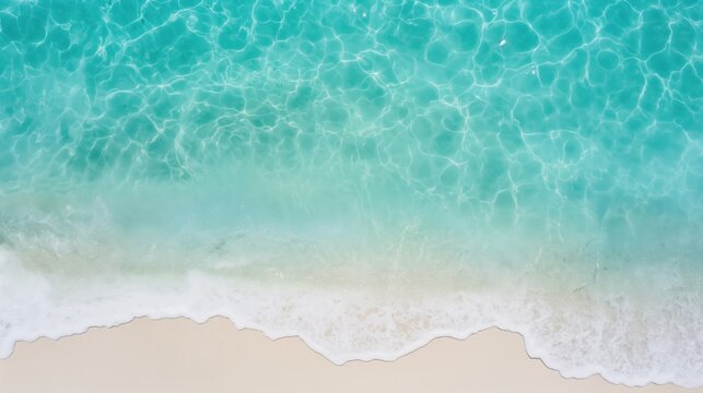 Top view of clear ocean water waves on sandy beach coast. Outdoor background with copy space.