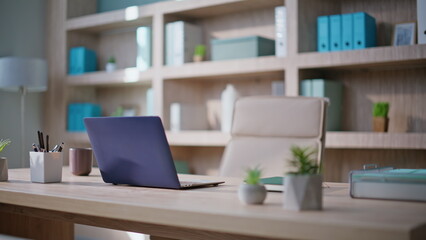 Contemporary minimalist office environment. Laptop standing at wooden desk
