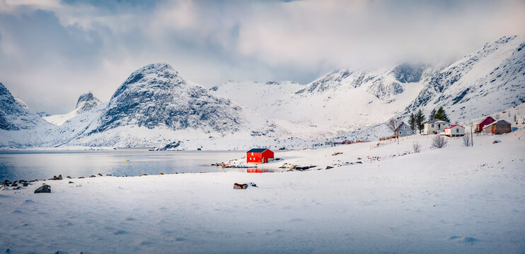 Gloomy morning view of Krystadveien village on the Sandvika bay. Gorgeous winter scene of Lofoten Islans, Norway, Europe. Wonderful seascape of Norwegian sea. Life over polar circle.