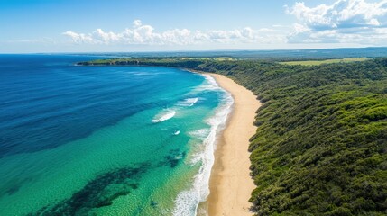 A beautiful beach with a green ocean and a rocky shore