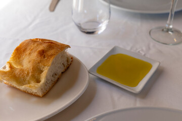 Homemade bread and olive oil for appetizer in restaurant Spain