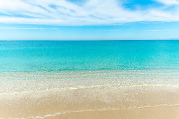 Turquoise water and golden sand in an empty beach